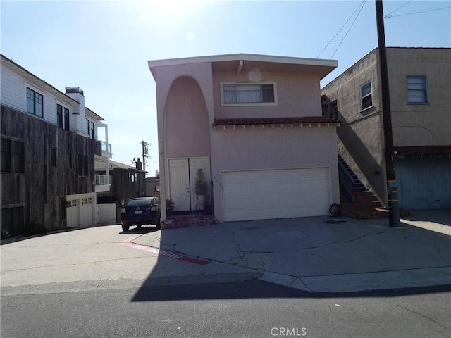 3513 Alma Ave, Manhattan Beach, CA 90266 - view of front of house with stucco siding, driveway, an attached garage, and stairway