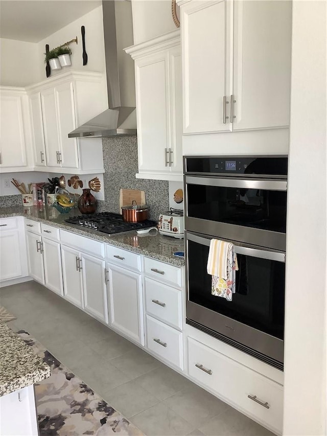 11915 Sagecrest Ct, Corona, CA 92883 - kitchen featuring stainless steel appliances, wall chimney exhaust hood, white cabinets, light stone counters, and backsplash