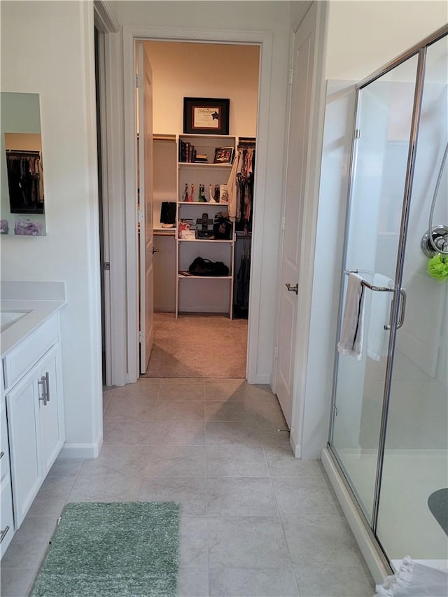 11915 Sagecrest Ct, Corona, CA 92883 - bathroom featuring a shower stall, a walk in closet, vanity, and tile patterned floors