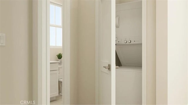 2557 E Hyde Paseo, Ontario, CA 91762 - laundry area featuring stacked washing machine and dryer and plenty of natural light