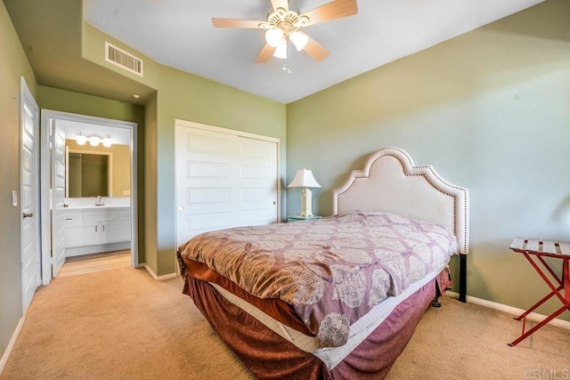 4021 Canario St Unit 235, Carlsbad, CA 92008 - bedroom with light carpet, baseboards, ensuite bathroom, a sink, and a closet