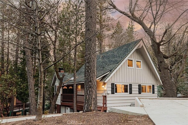 26625 Pinehurst Dr, Lake Arrowhead, CA 92352 - view of front facade featuring board and batten siding, roof with shingles, driveway, and a chimney