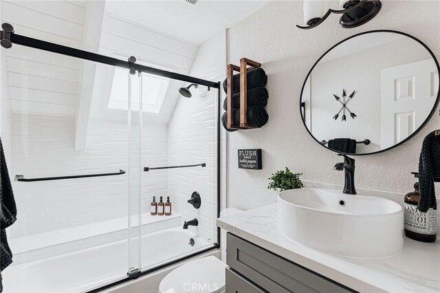 26625 Pinehurst Dr, Lake Arrowhead, CA 92352 - full bathroom with a textured wall, enclosed tub / shower combo, vanity, and toilet