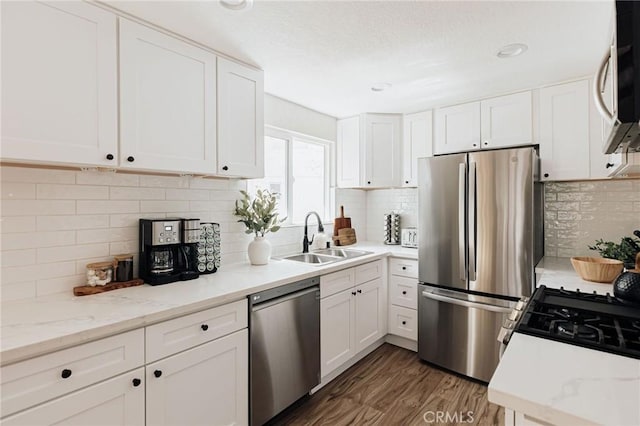 26625 Pinehurst Dr, Lake Arrowhead, CA 92352 - kitchen with appliances with stainless steel finishes, a sink, tasteful backsplash, and white cabinets