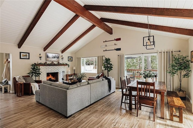26625 Pinehurst Dr, Lake Arrowhead, CA 92352 - living area featuring light wood-style floors, a fireplace, high vaulted ceiling, baseboards, and wooden ceiling with exposed beams