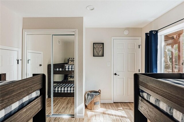26625 Pinehurst Dr, Lake Arrowhead, CA 92352 - bedroom featuring light wood finished floors, a closet, and baseboards