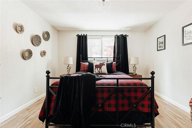 26625 Pinehurst Dr, Lake Arrowhead, CA 92352 - bedroom with wood finished floors, baseboards, and a textured ceiling
