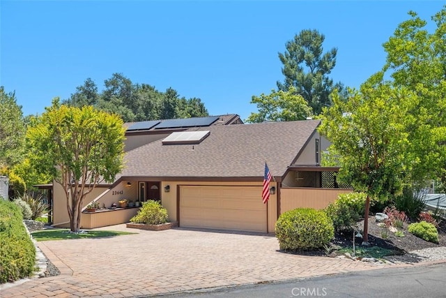 23442 Via Codorniz, Coto De Caza, CA 92679 - a-frame style home with an attached garage, solar panels, driveway, and a shingled roof