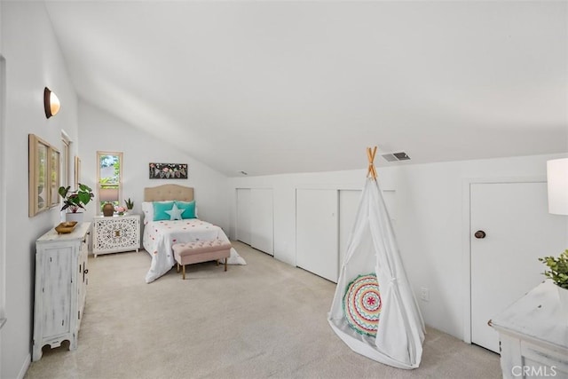 23442 Via Codorniz, Coto De Caza, CA 92679 - bedroom with light carpet, lofted ceiling, and two closets