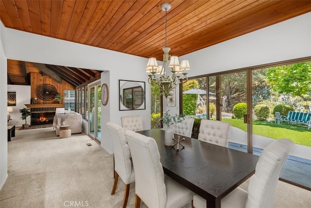 23442 Via Codorniz, Coto De Caza, CA 92679 - dining room with wood ceiling, healthy amount of natural light, a chandelier, carpet flooring, and a glass covered fireplace
