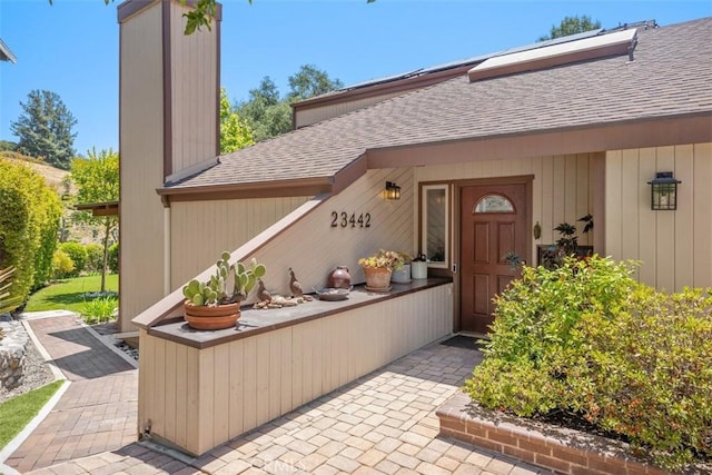 23442 Via Codorniz, Coto De Caza, CA 92679 - doorway to property with roof with shingles and solar panels
