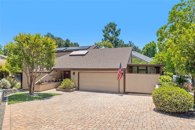 23442 Via Codorniz, Coto De Caza, CA 92679 - mid-century home with an attached garage, solar panels, decorative driveway, and roof with shingles
