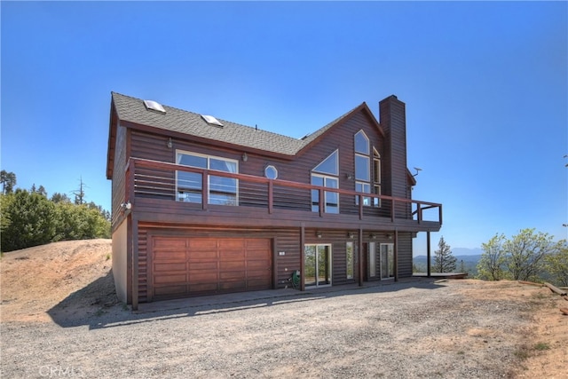 175 N Trails End Rd, Green Valley Lake, CA 92341 - view of front of property featuring a chimney, a shingled roof, an attached garage, and a wooden deck