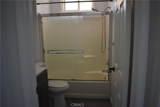 815 California Ave, Dos Palos, CA 93620 - full bathroom with toilet, vanity, and bath / shower combo with glass door