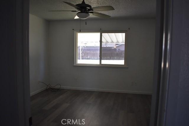 815 California Ave, Dos Palos, CA 93620 - spare room with a ceiling fan, wood finished floors, baseboards, and a textured ceiling