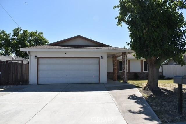 815 California Ave, Dos Palos, CA 93620 - single story home with driveway, a garage, and stucco siding