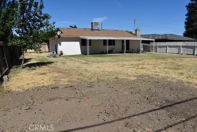 815 California Ave, Dos Palos, CA 93620 - back of house featuring a fenced backyard and central AC