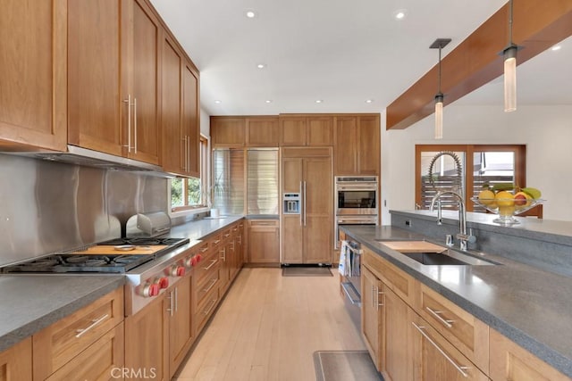 4315 Morro Dr, Woodland Hills, CA 91364 - kitchen featuring a sink, stainless steel appliances, dark countertops, light wood-type flooring, and recessed lighting