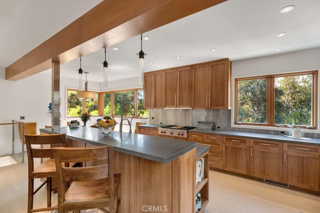 4315 Morro Dr, Woodland Hills, CA 91364 - kitchen featuring light wood-type flooring, brown cabinetry, dark countertops, and recessed lighting