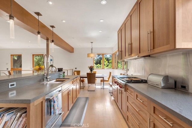 4315 Morro Dr, Woodland Hills, CA 91364 - kitchen with light wood-style floors, dark countertops, stainless steel gas stovetop, recessed lighting, and a sink
