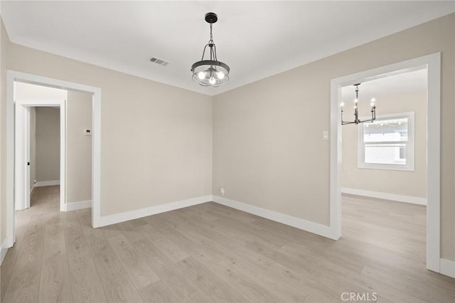 709 E 9th St, Pomona, CA 91766 - unfurnished room featuring a chandelier, light wood-type flooring, and baseboards