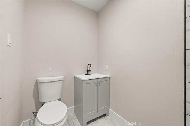 709 E 9th St, Pomona, CA 91766 - bathroom with baseboards, vanity, toilet, and marble finish floors