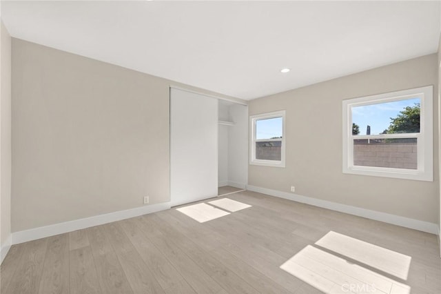 709 E 9th St, Pomona, CA 91766 - unfurnished bedroom with light wood-style floors, baseboards, recessed lighting, and a closet