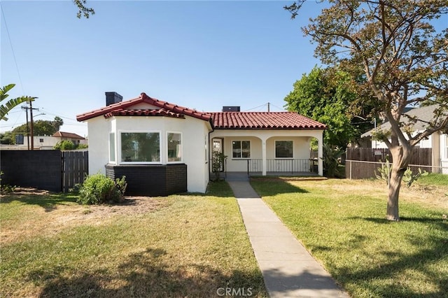 709 E 9th St, Pomona, CA 91766 - view of front of house with a chimney, stucco siding, a tiled roof, and a porch