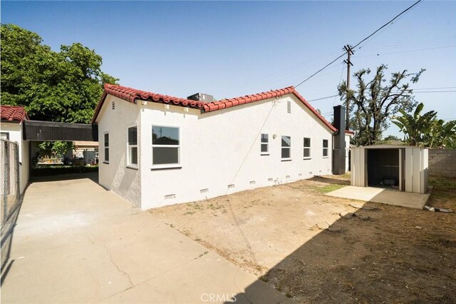 709 E 9th St, Pomona, CA 91766 - view of home's exterior featuring a tile roof, stucco siding, a patio, and crawl space