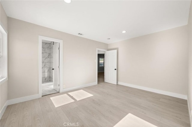 709 E 9th St, Pomona, CA 91766 - unfurnished bedroom featuring wood finished floors, baseboards, recessed lighting, and ensuite bathroom
