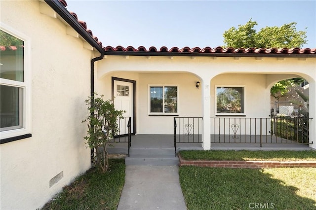 709 E 9th St, Pomona, CA 91766 - property entrance featuring a porch, stucco siding, and a tiled roof