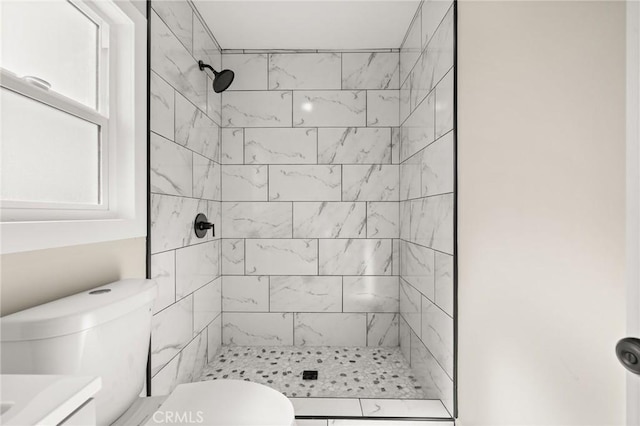 709 E 9th St, Pomona, CA 91766 - bathroom featuring a tile shower, toilet, and vanity