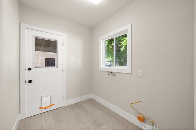 709 E 9th St, Pomona, CA 91766 - entryway with light wood-style floors and baseboards