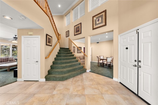 12719 E Rancho Estates Pl, Rancho Cucamonga, CA 91739 - entryway with light colored carpet, stairway, baseboards, a ceiling fan, and ornamental molding