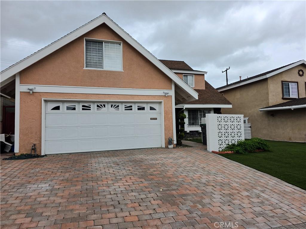 19312 Gunlock, Carson, CA 90746 - traditional home featuring decorative driveway, stucco siding, and a garage