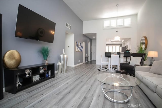 54229 Oakhill Ln, Quinta, CA 92253 - living room featuring a towering ceiling, wood finished floors, plenty of natural light, and baseboards
