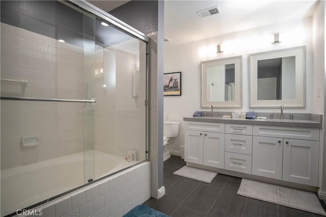 54229 Oakhill Ln, Quinta, CA 92253 - bathroom featuring toilet, double vanity, tiled shower / bath combo, and baseboards