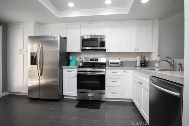 54229 Oakhill Ln, Quinta, CA 92253 - kitchen with appliances with stainless steel finishes, a sink, a raised ceiling, ornamental molding, and recessed lighting
