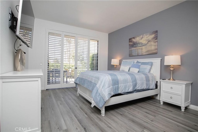 54229 Oakhill Ln, Quinta, CA 92253 - bedroom featuring access to outside and light wood-type flooring
