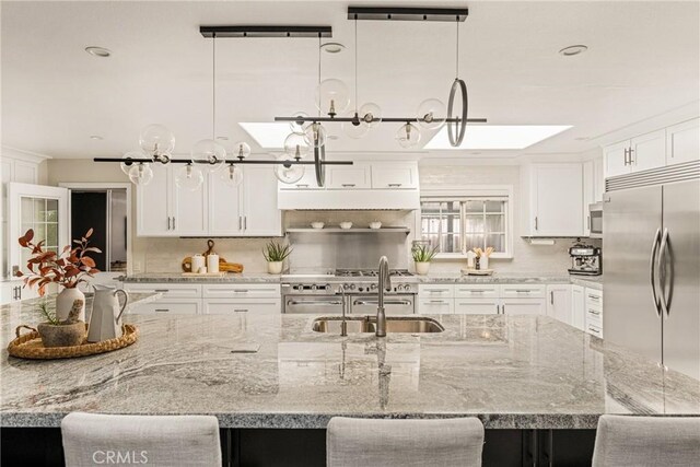 20402 Seven Seas Ln, Huntington Beach, CA 92646 - kitchen with premium appliances, decorative backsplash, a spacious island, white cabinetry, and recessed lighting