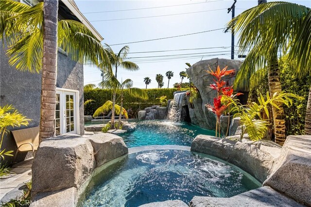 20402 Seven Seas Ln, Huntington Beach, CA 92646 - view of swimming pool featuring a pool with connected hot tub and french doors