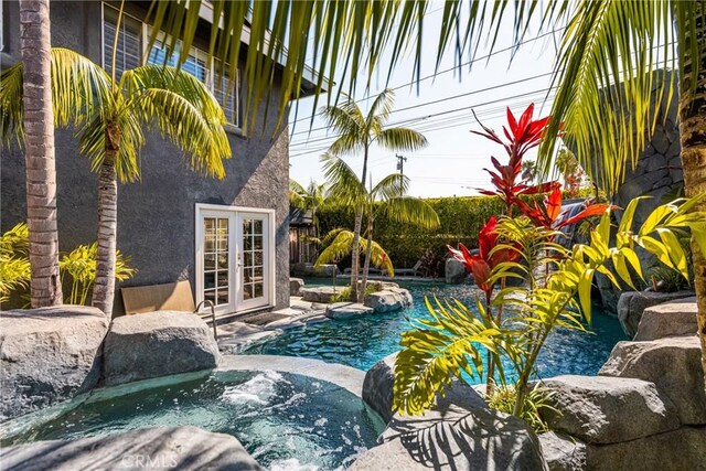 20402 Seven Seas Ln, Huntington Beach, CA 92646 - outdoor pool with french doors and a jacuzzi