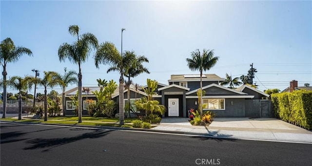 20402 Seven Seas Ln, Huntington Beach, CA 92646 - view of front of home featuring roof mounted solar panels