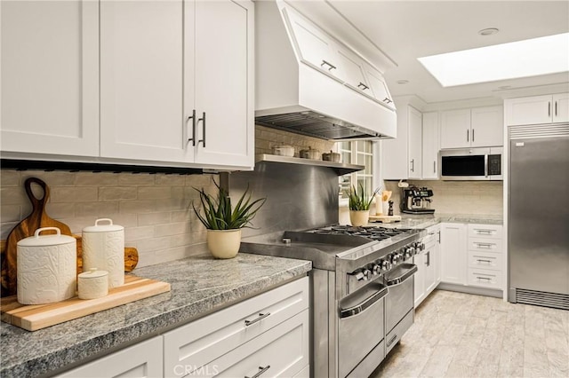 20402 Seven Seas Ln, Huntington Beach, CA 92646 - kitchen with high quality appliances, a skylight, and white cabinetry