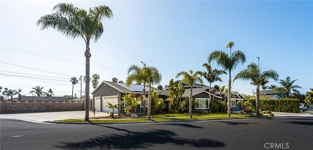 20402 Seven Seas Ln, Huntington Beach, CA 92646 - view of front of house with concrete driveway and solar panels
