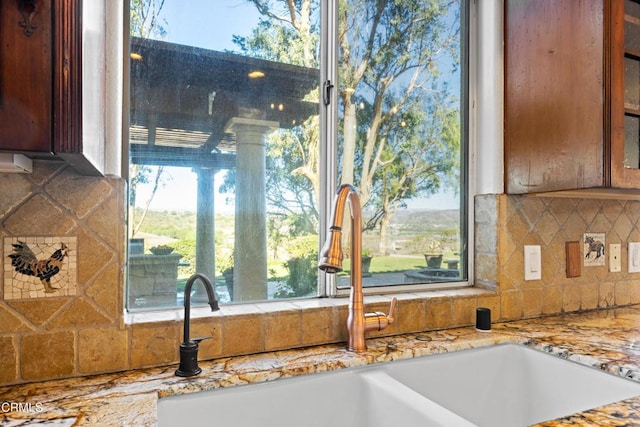 13045 Ripple Creek Ln, Camarillo, CA 93012 - kitchen view of backsplash, a sink, and glass insert cabinets