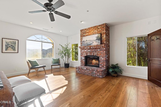 13045 Ripple Creek Ln, Camarillo, CA 93012 - living room with wood-type flooring, ceiling fan, baseboards, a fireplace, and a mountain view