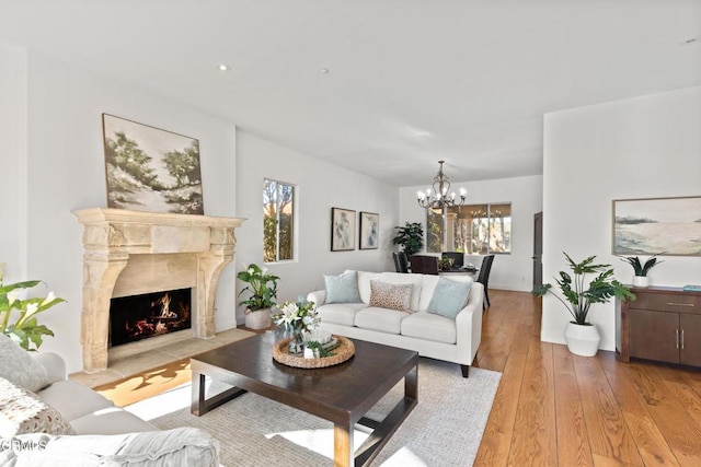 13045 Ripple Creek Ln, Camarillo, CA 93012 - living room with a chandelier, light wood-style flooring, and a premium fireplace