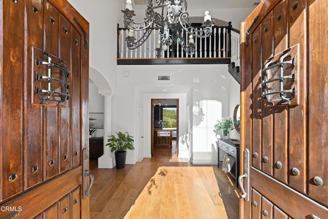 13045 Ripple Creek Ln, Camarillo, CA 93012 - entryway featuring arched walkways, wood finished floors, a chandelier, and baseboards