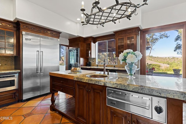 13045 Ripple Creek Ln, Camarillo, CA 93012 - kitchen with built in refrigerator, a sink, a chandelier, a warming drawer, and light tile patterned floors